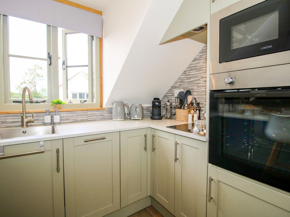 A kitchen with sink and appliances at Little Acre Leominster