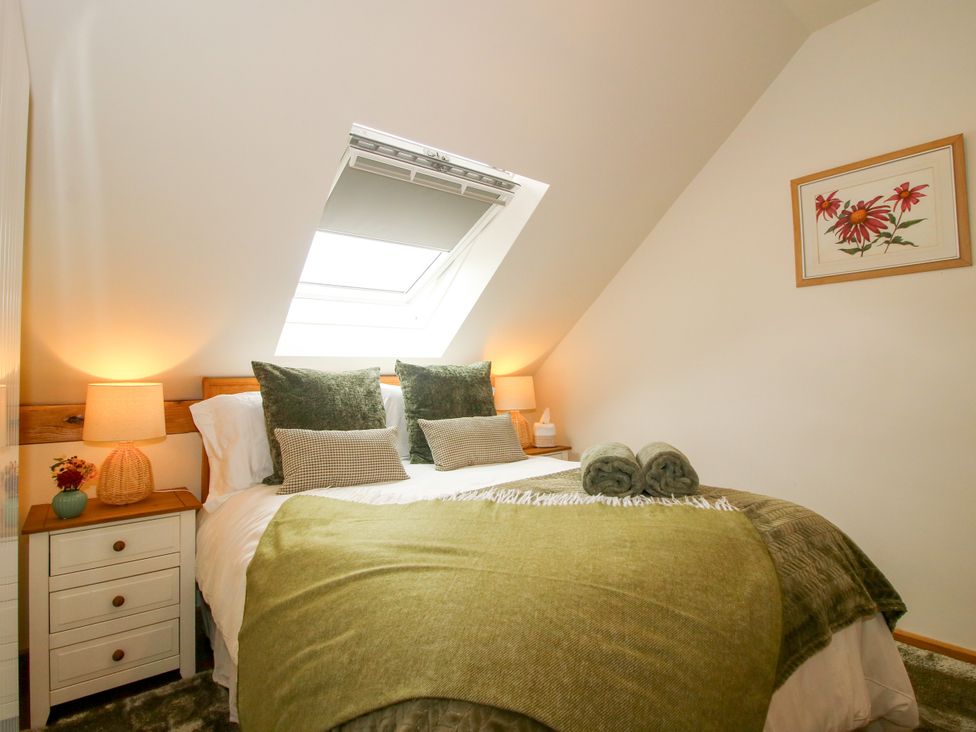 A bedroom with a bed and window at Little Acre Leominster