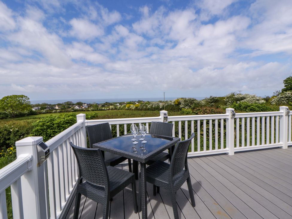 An outdoor patio with a table and chairs at The Dorchester at Bay View New Quay