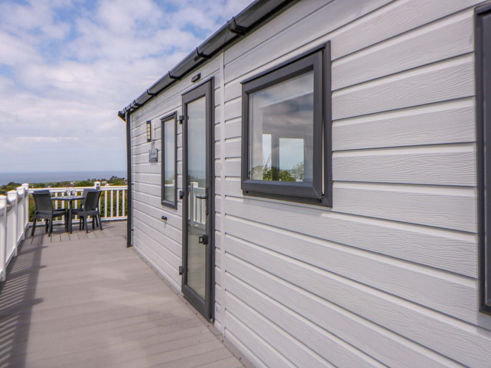 An outdoor area with a table and chairs at The Dorchester at Bay View New Quay