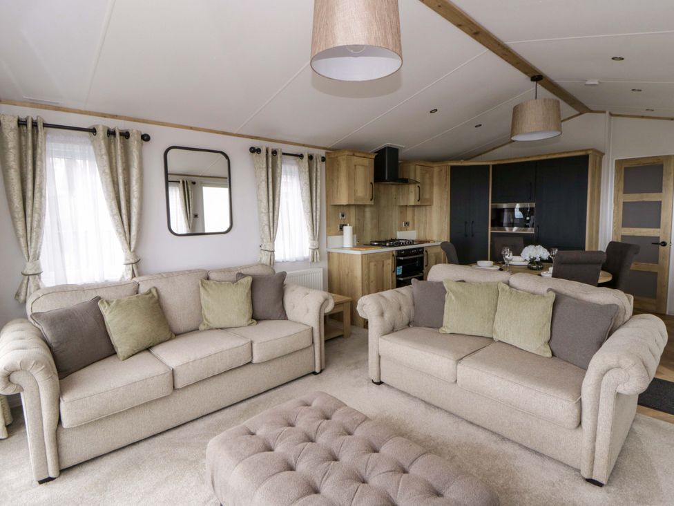 A living room with sofas and a coffee table at The Dorchester at Bay View in New Quay