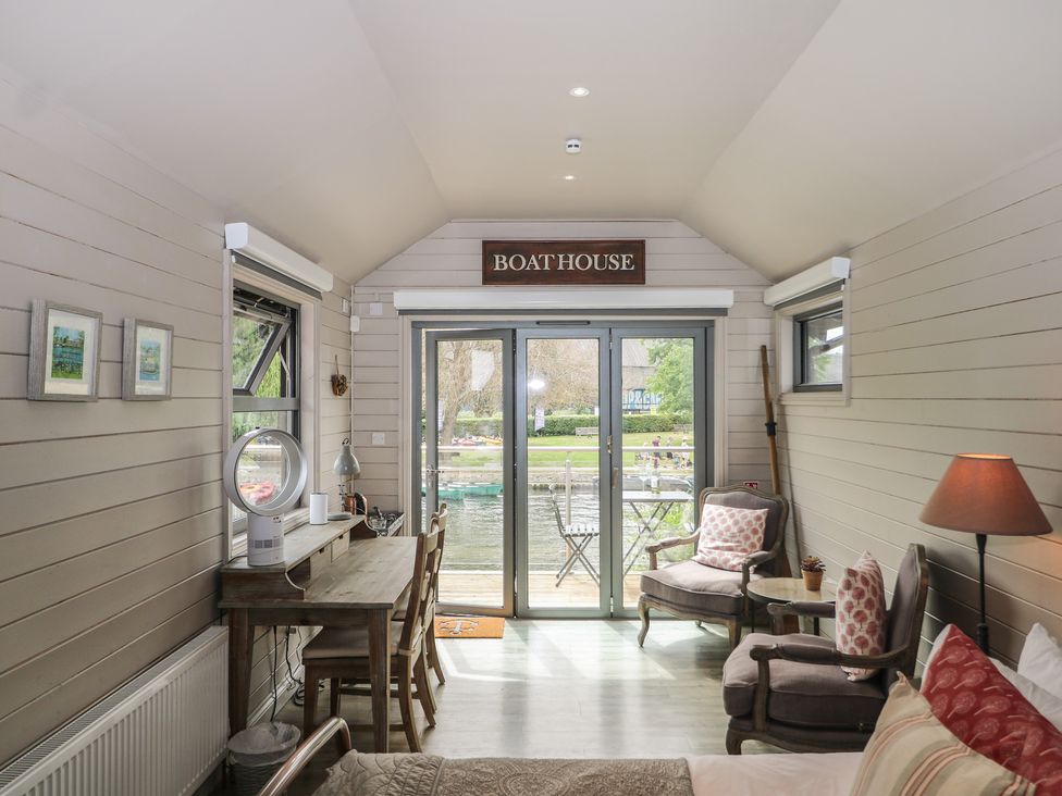 A living room with a boat house sign and seating at Island Cottage Rod eyot Henley-on-Thames