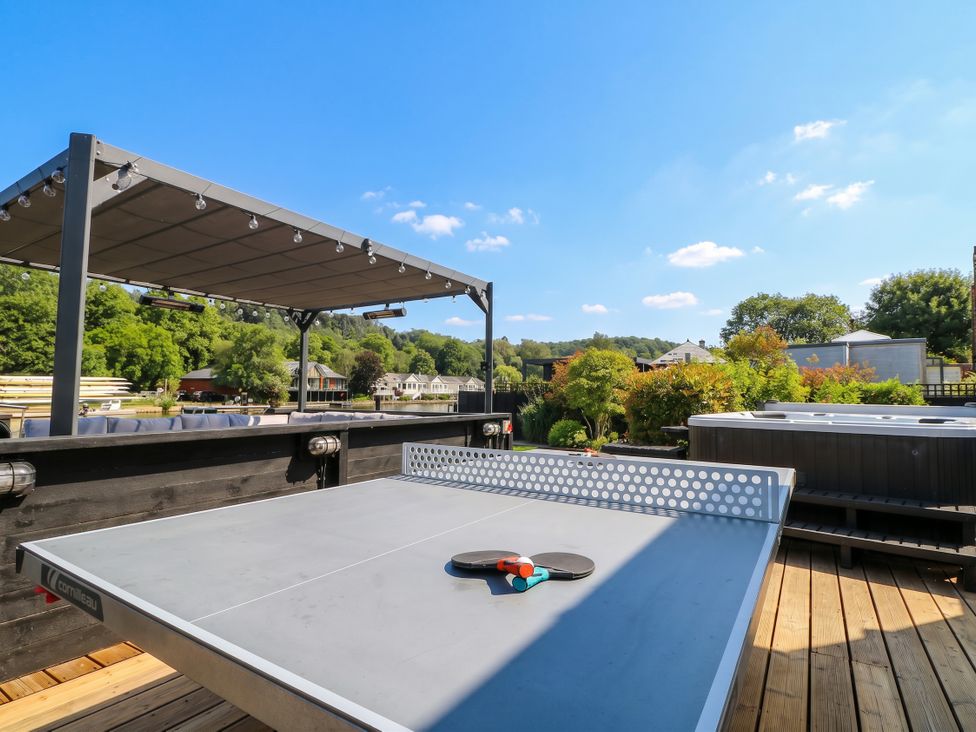 An outdoor area with a ping pong table and hot tub at Island Cottage Rod eyot Henley-on-Thames
