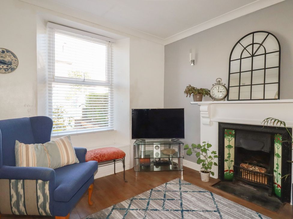 A living room with a television and an armchair at 39 Southgate Street