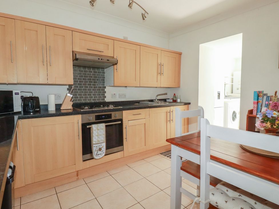 A kitchen with wooden cabinets and appliances at 39 Southgate Street