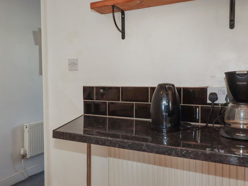 A kitchen with a kettle and coffee maker on the counter at 39 Southgate Street
