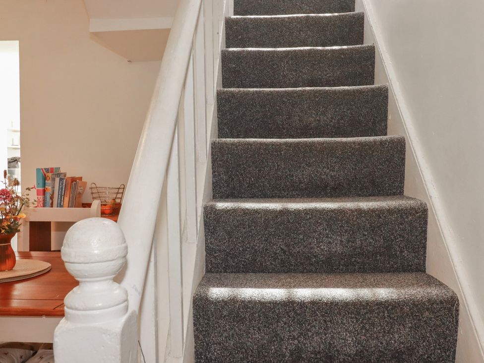 Stairs leading upward with a handrail at Tin Lantern Cottage Redruth