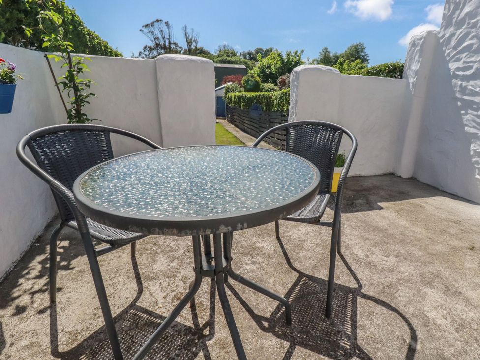 A table with chairs in a patio area at Tin Lantern Cottage Redruth