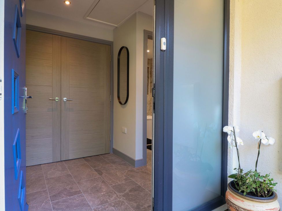 An entrance with a mirror and double doors at Elmcroft Nottingham