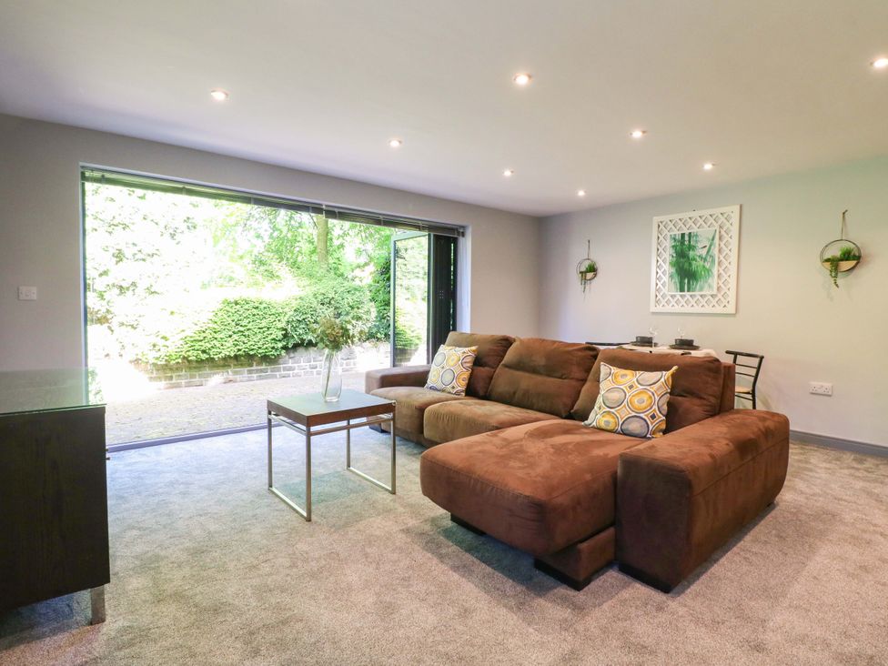 A living room with a sofa and coffee table at Elmcroft Nottingham