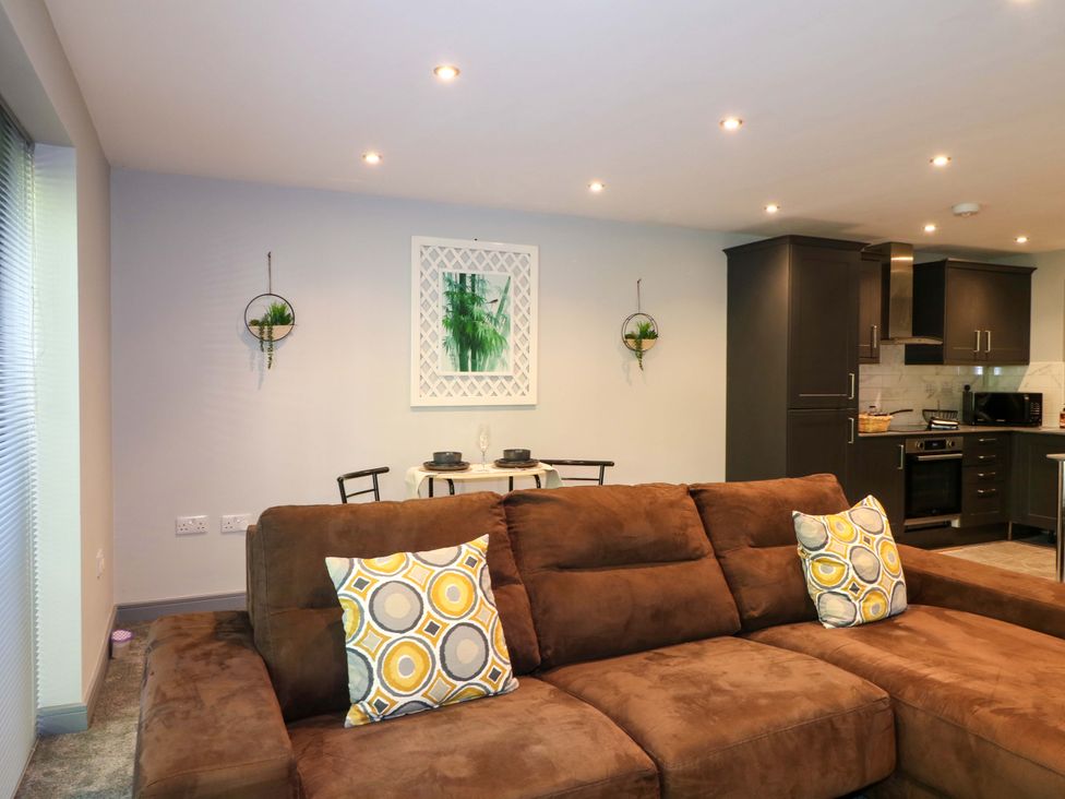 A living room with a sofa and dining area at Elmcroft in Nottingham