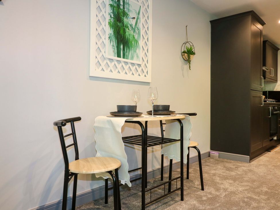 A dining area with a small table and two chairs at Elmcroft Nottingham