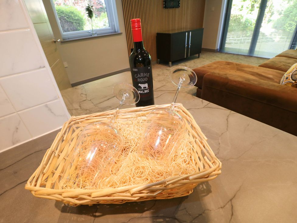 A basket with wine glasses and a wine bottle at Elmcroft Nottingham