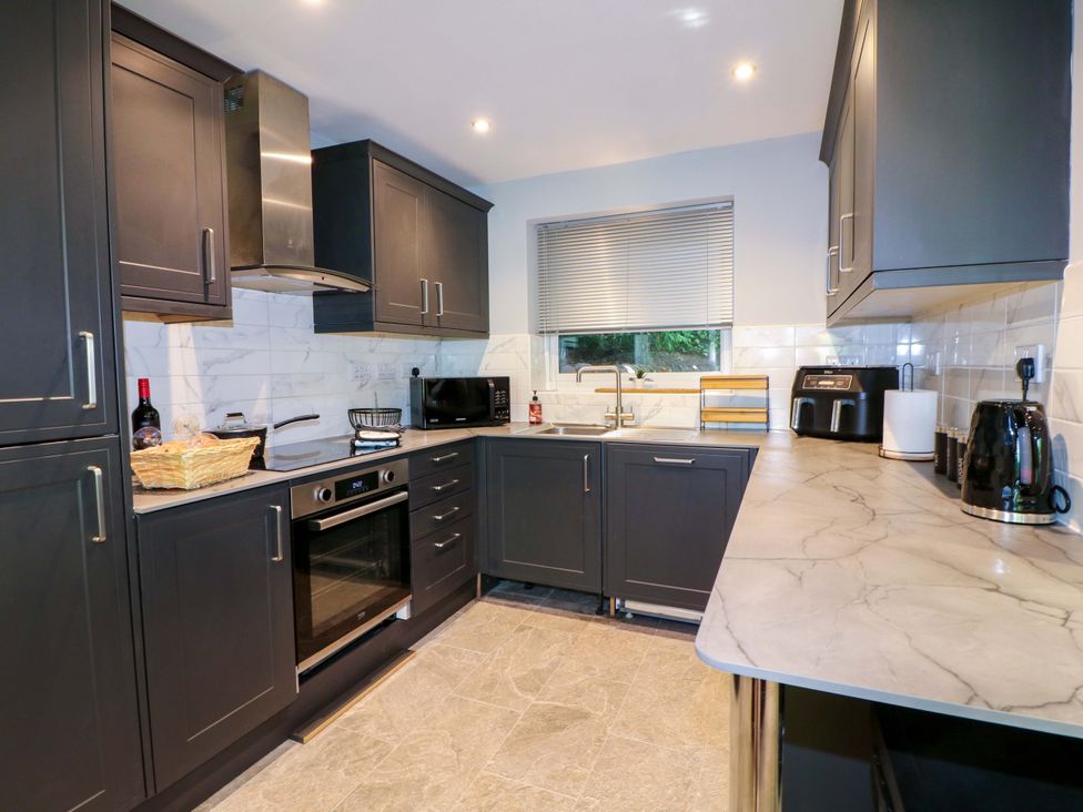 A kitchen with cabinets and appliances at Elmcroft in Nottingham