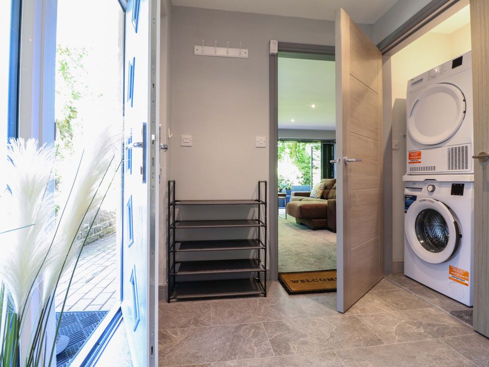 A laundry room with a washing machine and dryer at Elmcroft Nottingham