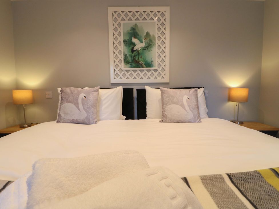 A bedroom with a bed and artwork at Elmcroft in Nottingham