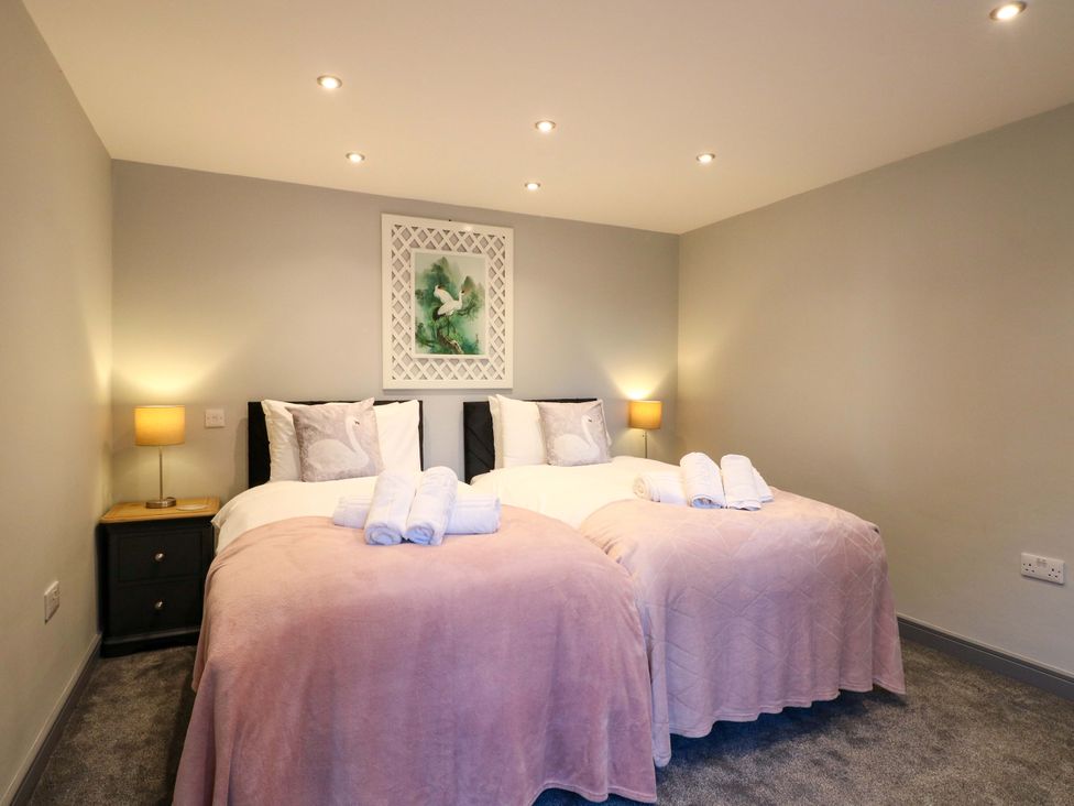 A bedroom with twin beds and a nightstand at Elmcroft Nottingham