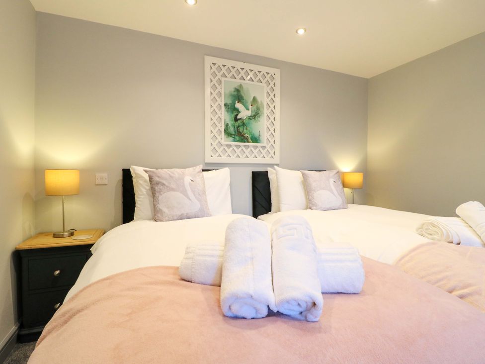 A bedroom with two beds and decorative items at Elmcroft in Nottingham