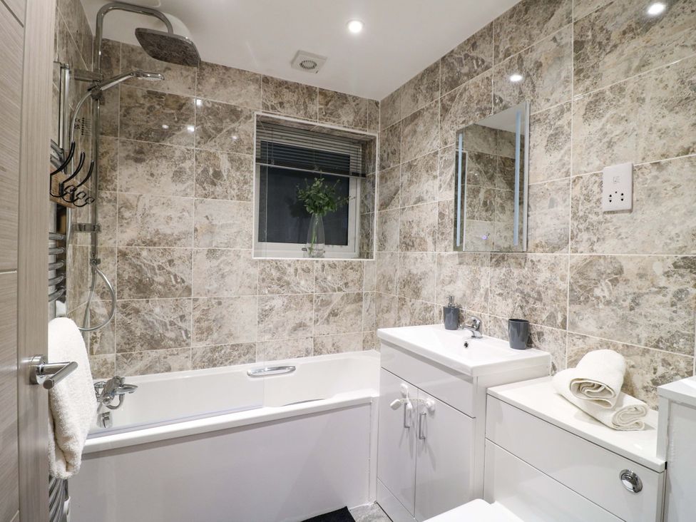 A bathroom with a bathtub and sink at Elmcroft in Nottingham