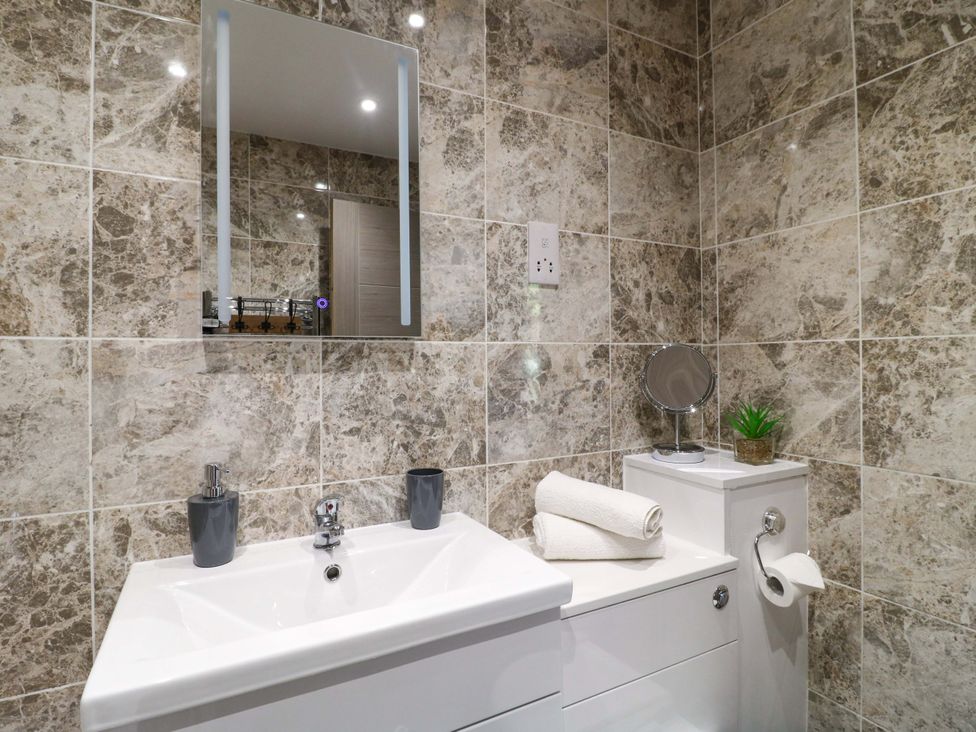A bathroom with a sink and mirror at Elmcroft Nottingham