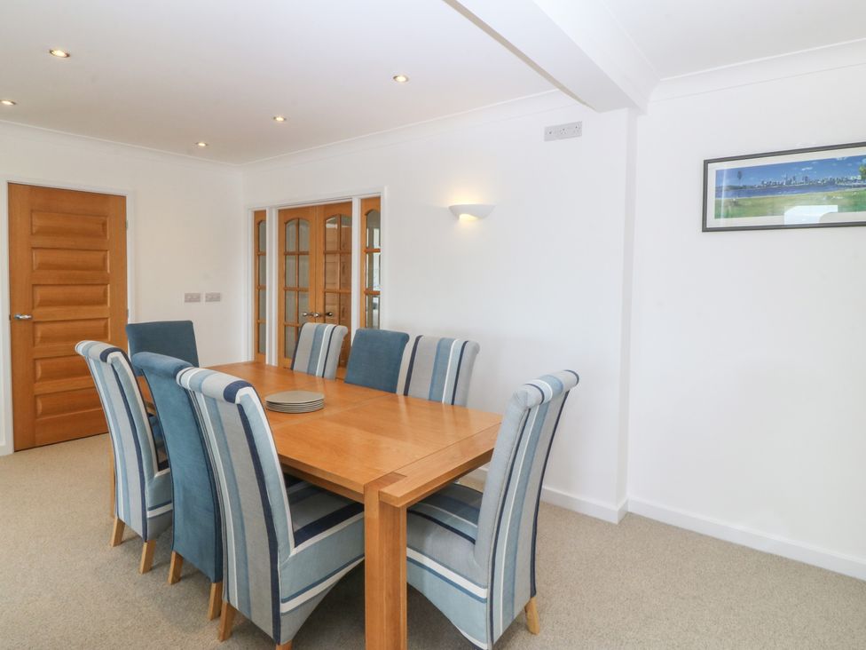 A dining room with a wooden table and chairs at Hillside