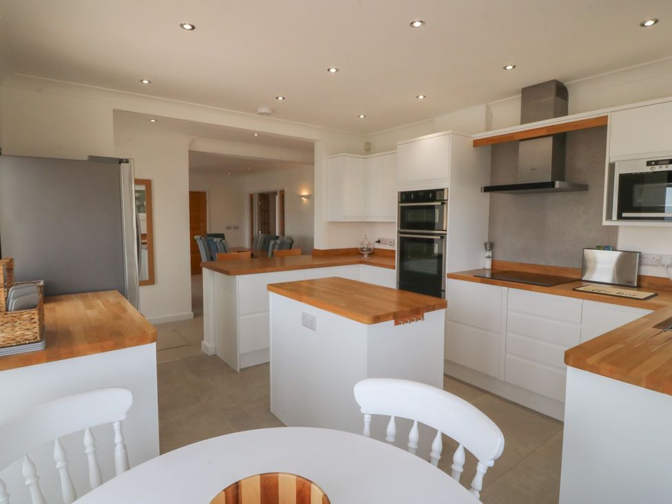 A kitchen with white cabinets and wooden countertops at Hillside