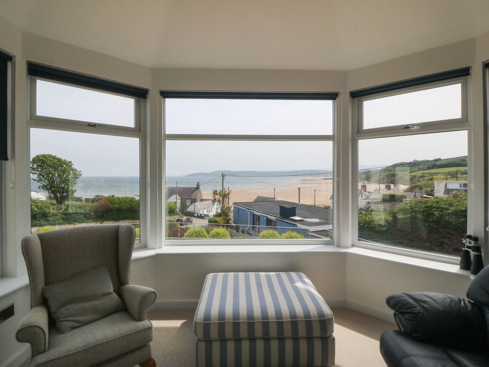 A living room with views of the sea and beach at Hillside