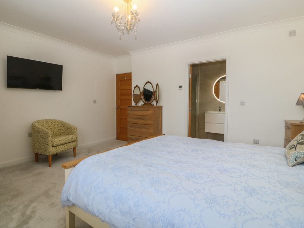 A bedroom with a bed, chair, and television at Hillside
