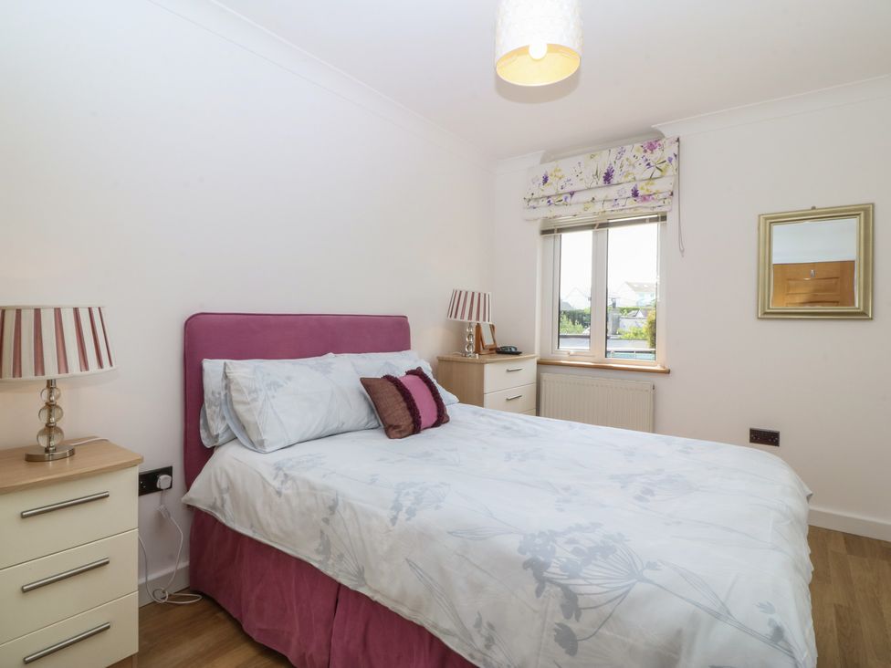 A bedroom with a bed and bedside table at Hillside