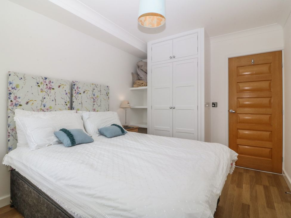 A bedroom with a bed and wardrobe at Hillside 
