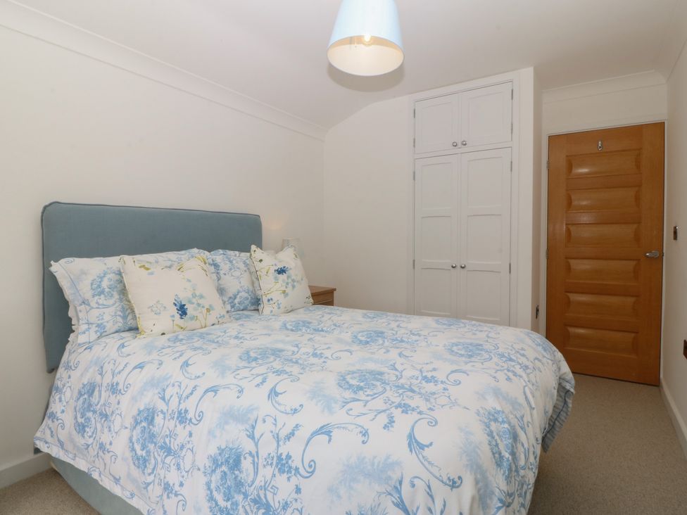 A bedroom with a bed and wardrobe at Hillside