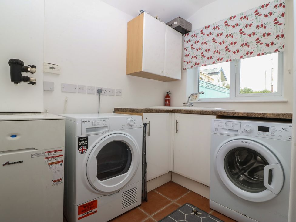 A laundry room with a washing machine and tumble dryer at Hillside