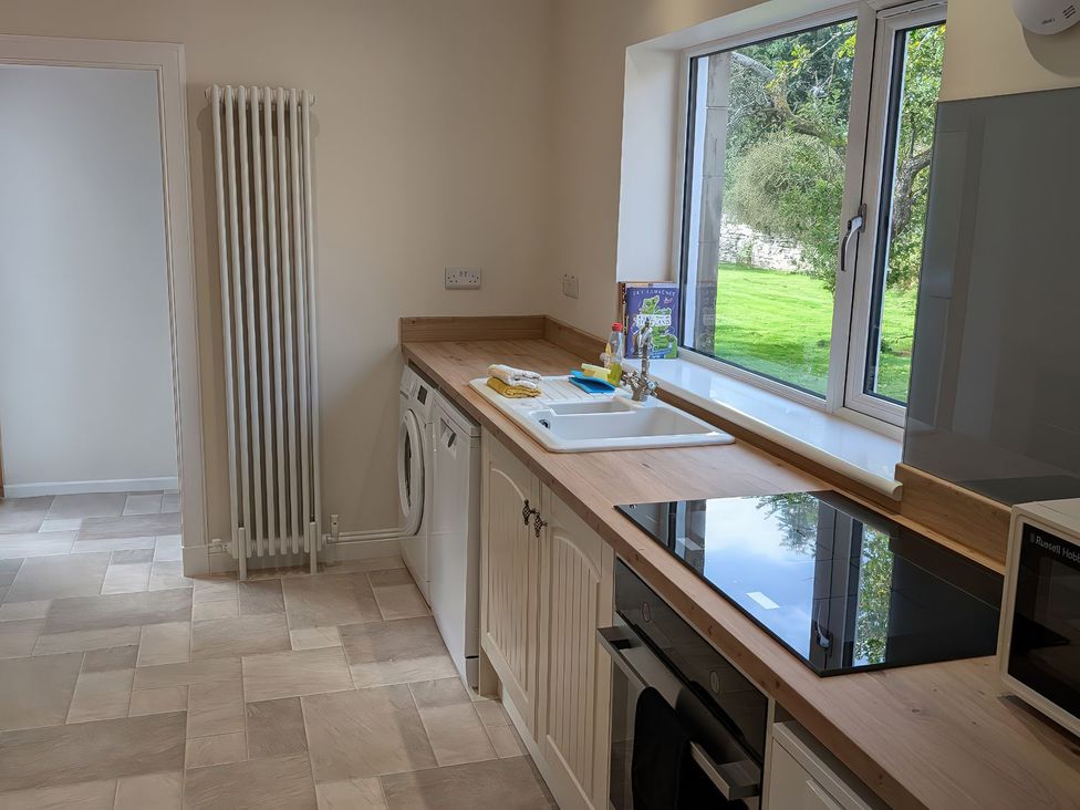 A kitchen with a sink and washing machine at Edengrove Aberfeldy