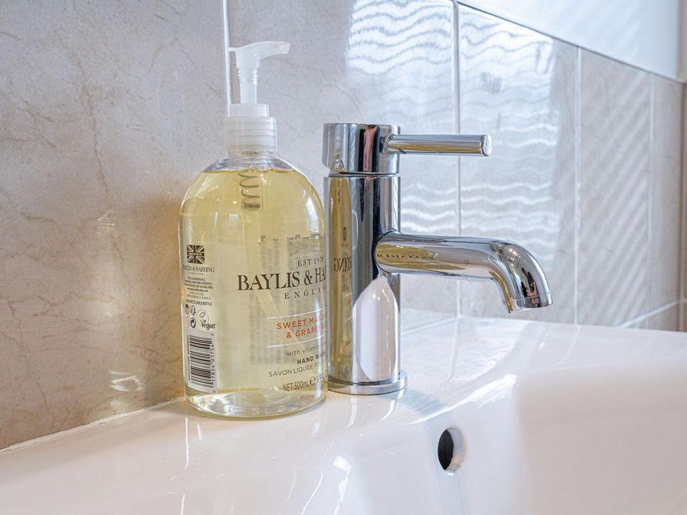 Soap dispenser and faucet in a bathroom at Edengrove in Aberfeldy