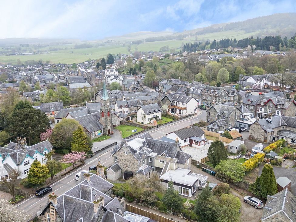 An aerial view of a town with houses and a church at Edengrove Aberfeldy