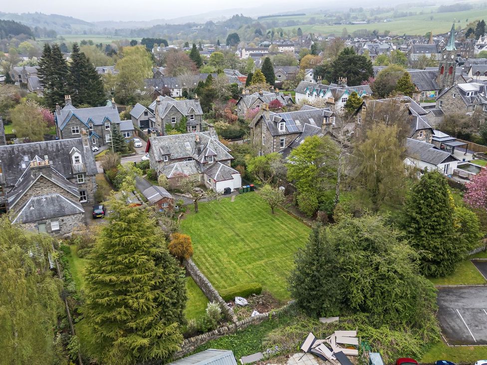 An aerial view of a residential area with houses and gardens at Edengrove in Aberfeldy
