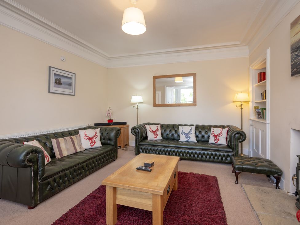 A living room with a sofa and coffee table at Edengrove Aberfeldy