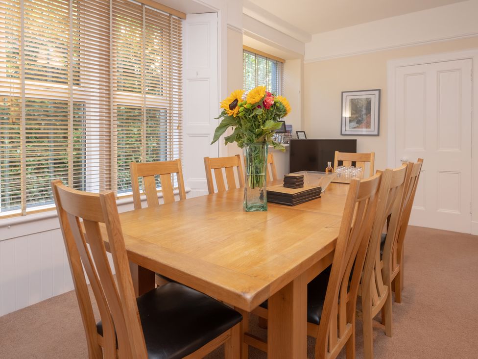 A dining room with a wooden table and chairs at Edengrove in Aberfeldy