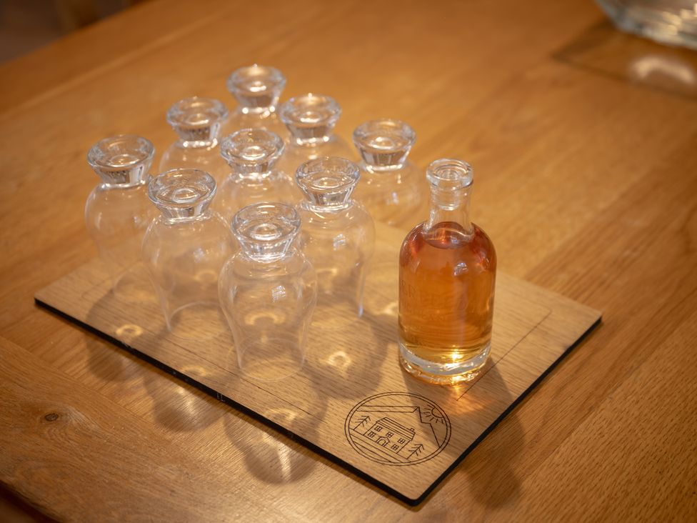 A collection of glass bottles on a wooden board at Edengrove in Aberfeldy