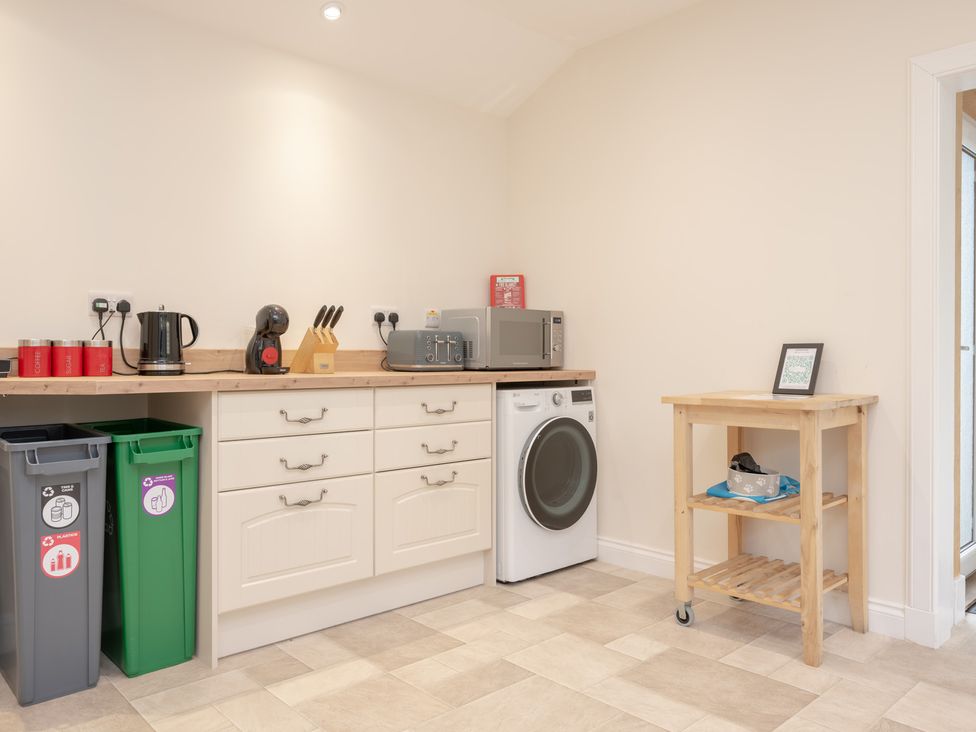 A kitchen with cabinets, appliances and a trolley at Edengrove in Aberfeldy