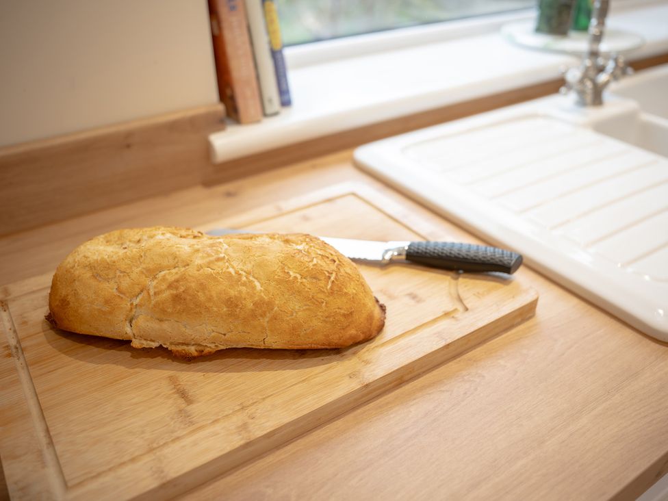 A loaf of bread on a cutting board in a kitchen at Edengrove, Aberfeldy