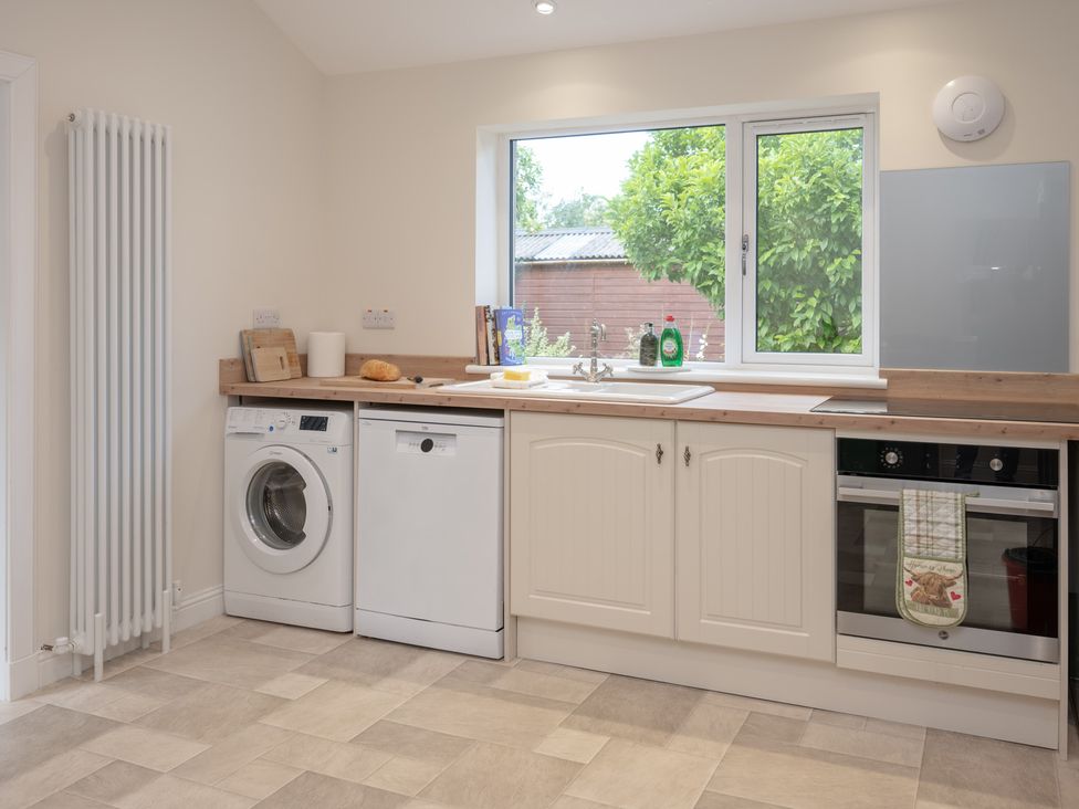 A kitchen with a sink and appliances at Edengrove in Aberfeldy