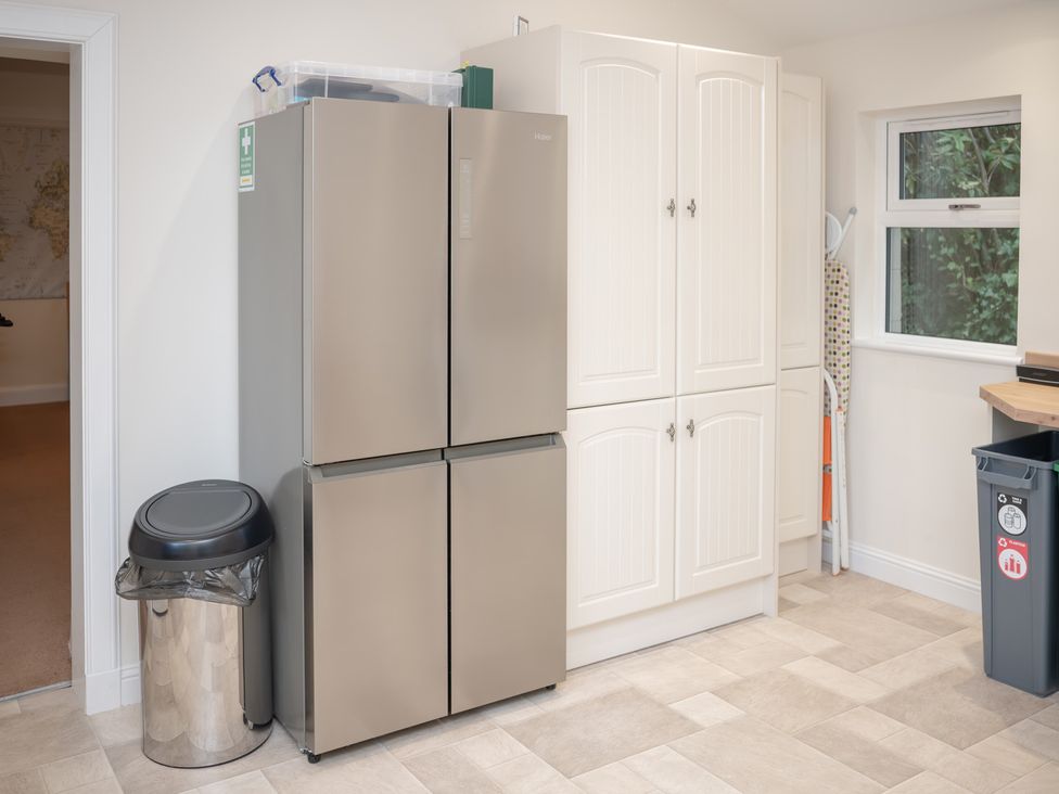A kitchen with a fridge and cupboard in Edengrove Aberfeldy