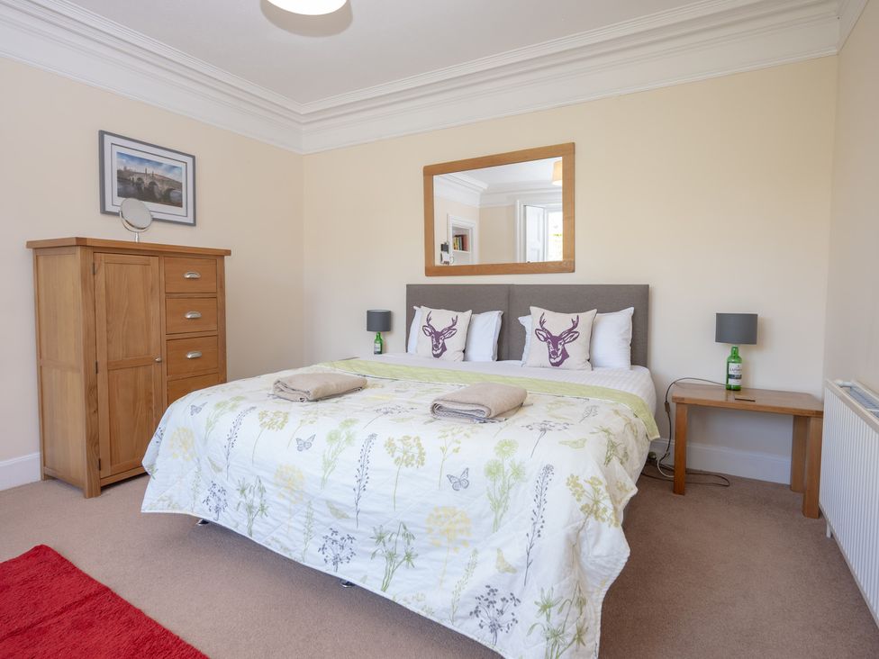 A bedroom with a double bed and bedside table at Edengrove in Aberfeldy