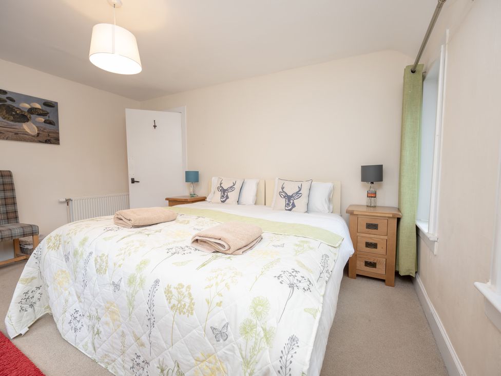 A bedroom with a bed and bedside table at Edengrove Aberfeldy