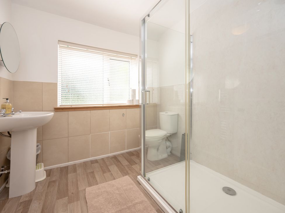 A bathroom with a sink, toilet, and shower at Edengrove in Aberfeldy