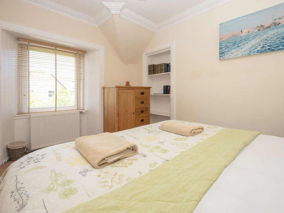 A bedroom with a bed and dresser at Edengrove in Aberfeldy