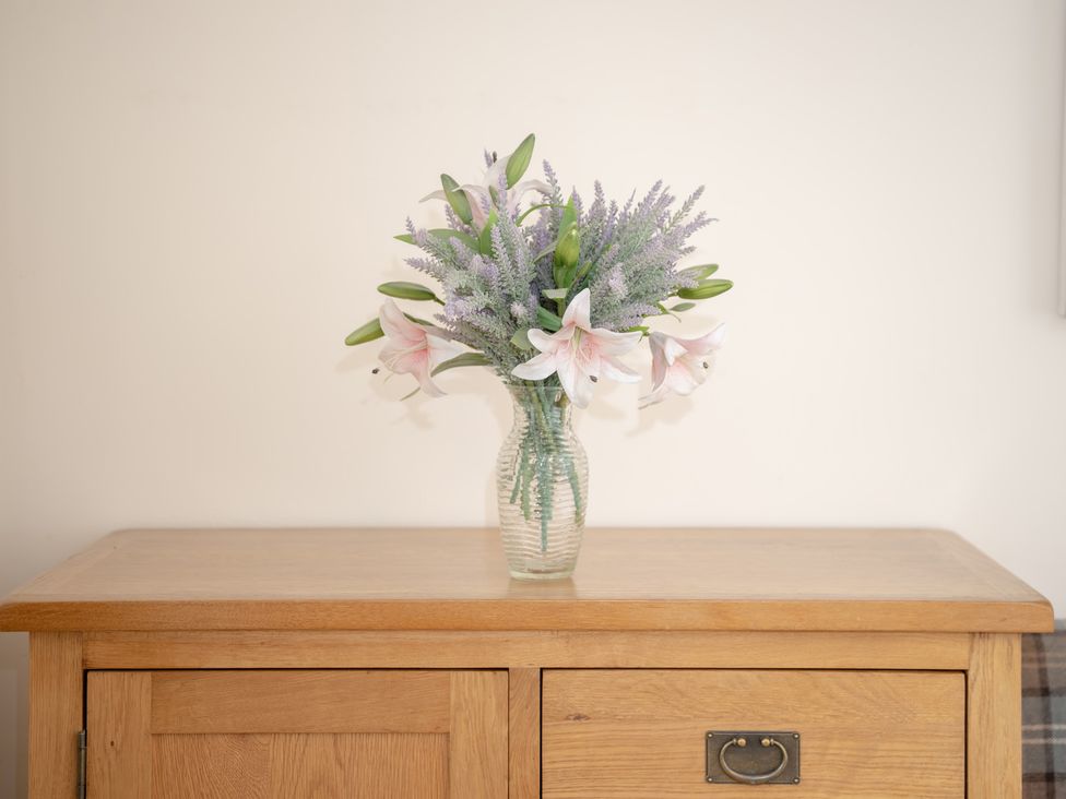 A flower vase on a wooden table at Edengrove in Aberfeldy