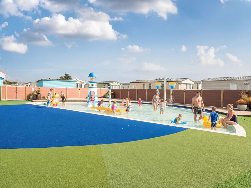 A swimming pool area with children and adults at Tide’s Reach - Hayling Island