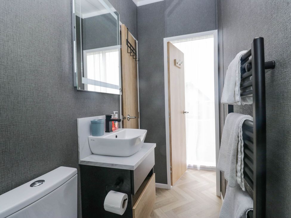 A bathroom with a sink and toilet at Heron in Haverigg